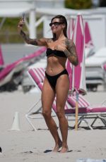 SOPHIA THOMALLA in a Black Bikini at a Beach in Miami 03/21/2023