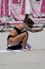 SOPHIA THOMALLA in a Black Bikini at a Beach in Miami 03/21/2023