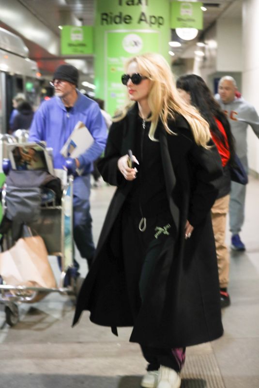 KATHRYN NEWTON Arrives at LAX Airport in Los Angeles 04/11/2023