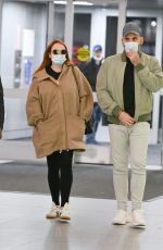 LINDSAY LOHAN and Husband Bader Shammas at JFK Airport in New York 04/18/2023 