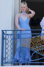 ELLE FANNING at a Photoshoot on Her Hotel Balcony in Cannes 05/16/2023