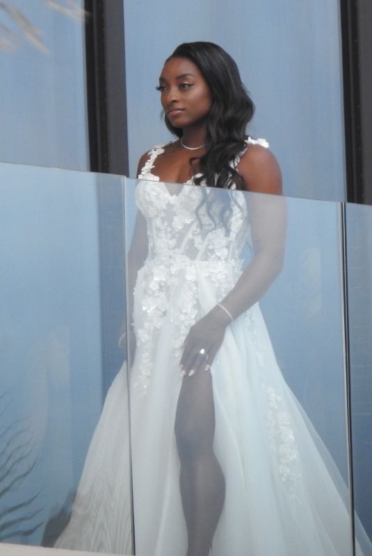 SIMONE BILES on Her Balcony Getting Ready for Ties the Knot with Jonathan Owens in Cabo San Lucas 05/06/2023 