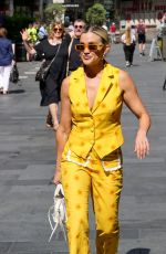 ASHLEY ROBERTS in a Bright Yellow Trousers and Waistcoat Leaves Heart Breakfast Show in London 06/21/2023
