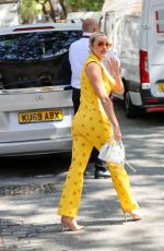 ASHLEY ROBERTS in a Bright Yellow Trousers and Waistcoat Leaves Heart Breakfast Show in London 06/21/2023
