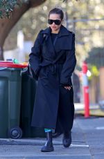 RITA ORA in a Black Trench Coat Out in Sydney 06/20/2023