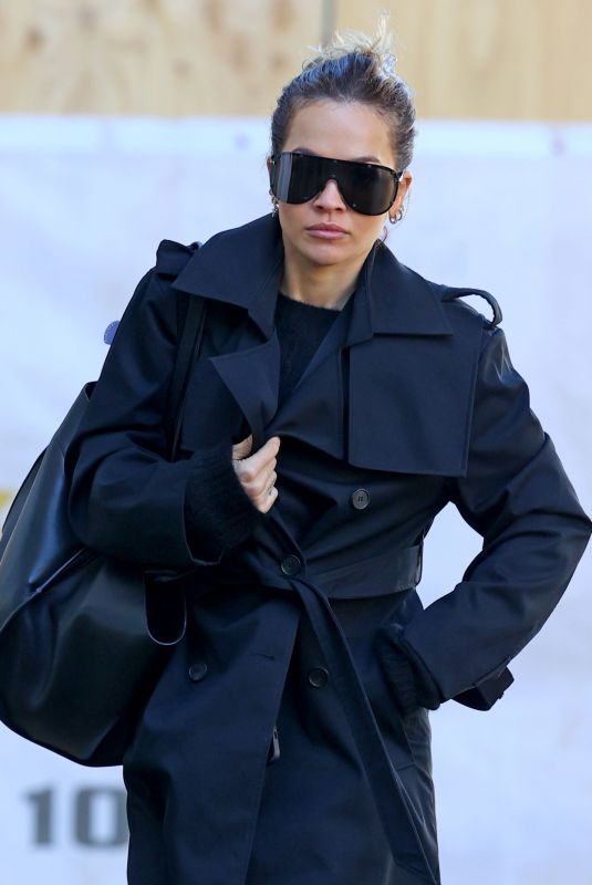 RITA ORA in a Black Trench Coat Out in Sydney 06/20/2023