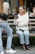 ELLEN POMPEO Waiting on a Park Bench at Bar Pitti in New York 06/30/2023