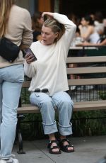 ELLEN POMPEO Waiting on a Park Bench at Bar Pitti in New York 06/30/2023