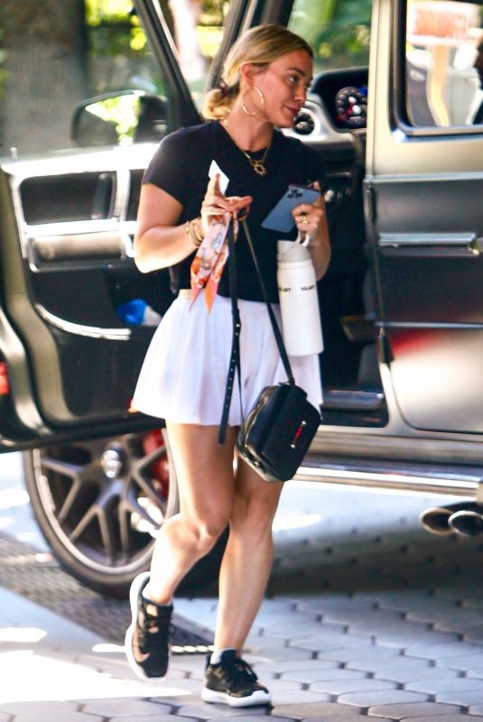 HILARY DUFF in a White Miniskirt Arrives at Sunset Towers in West Hollywood 07/11/2023
