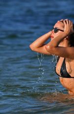 KIMBERLEY GARNER in a Black Bikini at Beach at Cheval Blanc Hotel in Saint-Tropez 07/27/2023