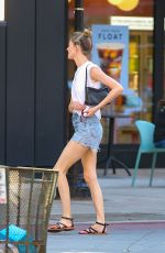 MARTHA HUNT in Denim Shorts and a White Tank Top Out in New York 07/24/2023