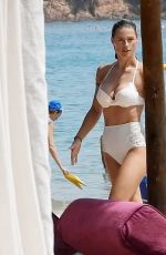 MICHELLE HUNZIKER in a White Bikini at a Beach in Sardinia 07/24/2023