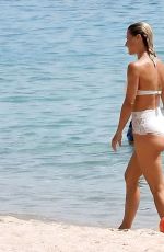 MICHELLE HUNZIKER in a White Bikini at a Beach in Sardinia 07/24/2023