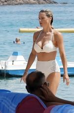 MICHELLE HUNZIKER in a White Bikini at a Beach in Sardinia 07/24/2023