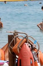 MICHELLE HUNZIKER in a White Bikini at a Beach in Sardinia 07/24/2023