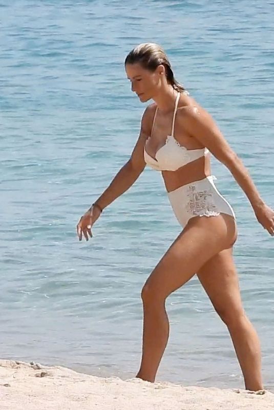 MICHELLE HUNZIKER in a White Bikini at a Beach in Sardinia 07/24/2023