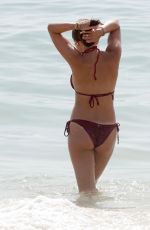 AMBER WISE in a Red Bikini at a Beach in Faro 08/25/2023