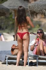 AMBER WISE in a Red Bikini at a Beach in Faro 08/25/2023