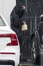 ARIANA MADIX Braves the Storm as She Arrives at Her Home in Los Angeles 08/20/2023