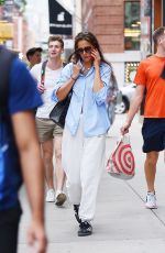 KATIE HOLMES Chats on Her Phone Out in New York 08/09/2023