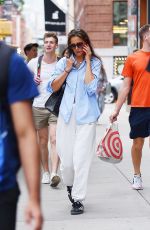 KATIE HOLMES Chats on Her Phone Out in New York 08/09/2023