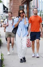 KATIE HOLMES Chats on Her Phone Out in New York 08/09/2023