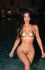 KIM KARDASHIAN in a Golden Bikini at a Photoshoot 08/14/2023