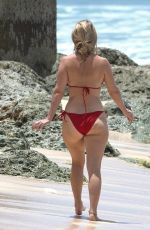 ALICE EVE in a Red Bikini at a Beach in Barbados 09/06/2023