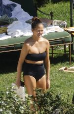 CHRISSY TEIGEN in Swimsuit at a Swimming Pool in Lake Como 09/14/2023
