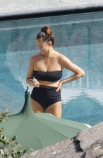 CHRISSY TEIGEN in Swimsuit at a Swimming Pool in Lake Como 09/14/2023