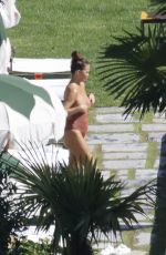 CHRISSY TEIGEN in Swimsuit at a Swimming Pool in Lake Como 09/14/2023