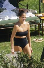 CHRISSY TEIGEN in Swimsuit at a Swimming Pool in Lake Como 09/14/2023