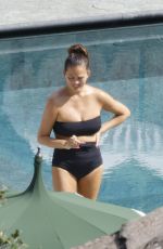 CHRISSY TEIGEN in Swimsuit at a Swimming Pool in Lake Como 09/14/2023