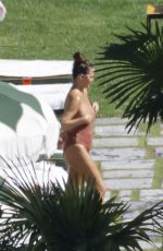 CHRISSY TEIGEN in Swimsuit at a Swimming Pool in Lake Como 09/14/2023