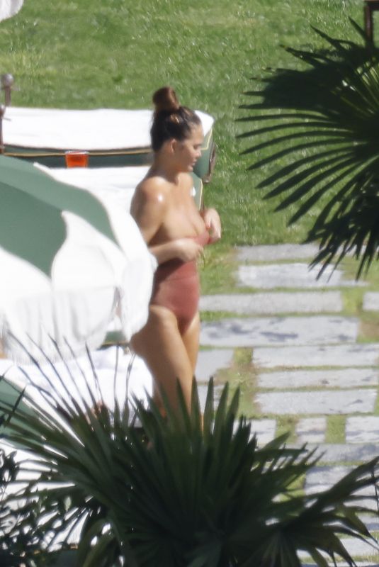 CHRISSY TEIGEN in Swimsuit at a Swimming Pool in Lake Como 09/14/2023