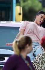 KATIE PRICE Climbs onto a Vivid Pink Car Outside Neighbourhood Restaurant in Liverpool 09/04/2023