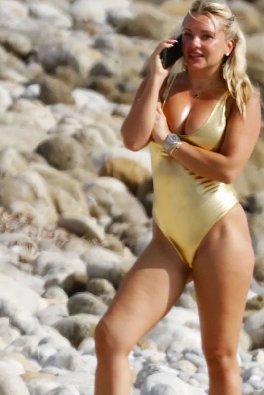 EVELYN BURDECKI in a Golden Swimsuit at a Beach in Ibiza, October 2023