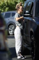 KALEY CUOCO Paused for a Friendly Chat in a Parking Lot in Malibu 11/23/2023
