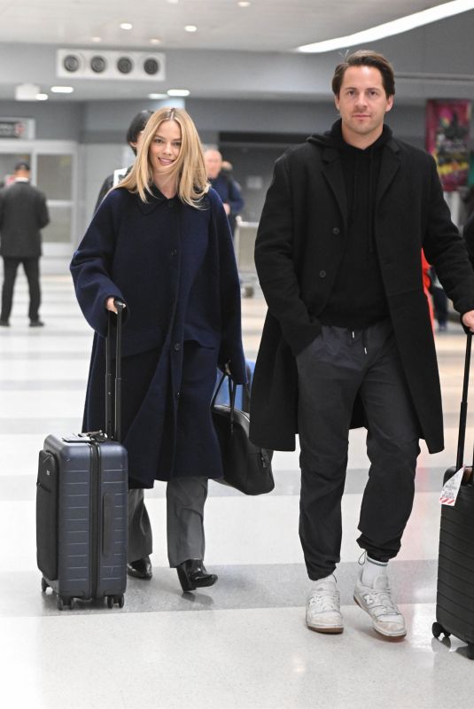 MARGOT ROBBIE and Tom Ackerley at JFK Airport in New York 11/26/2023