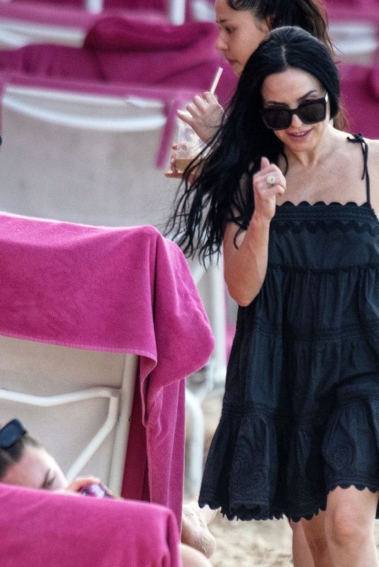 ANDREA CORR Relaxing on the Beach at Sandy Lane Hotel in Barbados 12/28/2023