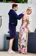 CORA SCHUMACHER Getting a Personal Rub Down with Sunscreen at Gold Coast 01/18/2024