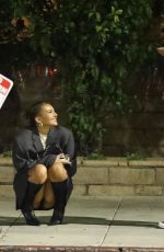 KATARINA DEME Squats on Sidewalk while Waiting for Her Car in Beverly Hills 01/19/2024