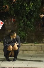 KATARINA DEME Squats on Sidewalk while Waiting for Her Car in Beverly Hills 01/19/2024