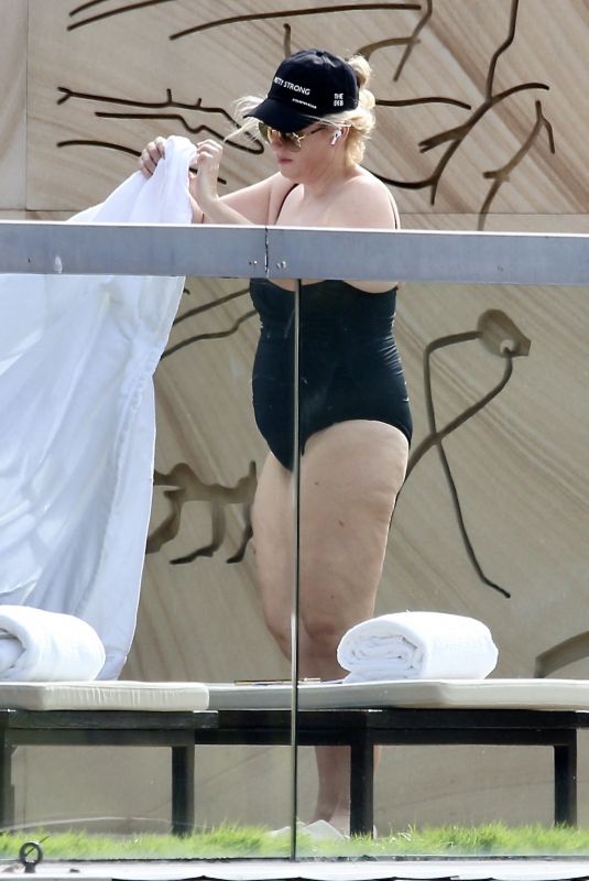 REBEL WILSON in Swimsuit at a Pool at Her Hotel in Sydney 01/05/2024
