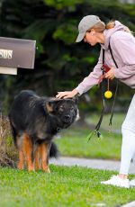 GISELE BUNDCHEN on a Dog Walk in Miami Beach 02/23/2024