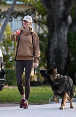 GISELE BUNDCHEN Out with Her German Shepherd in Surfside 02/22/2024