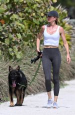 GISELE BUNDCHEN Out with Her German Shepherd at Beach Path in Surfside 03/03/2024