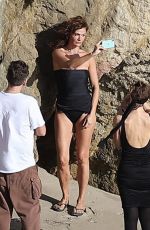 HELENA CHRISTENSEN in Swimsuit at a Phostohoot on the Beach in Malibu 03/12/2024