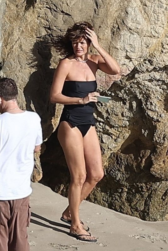 HELENA CHRISTENSEN in Swimsuit at a Phostohoot on the Beach in Malibu 03/12/2024