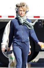 KATE HUDSON Steps Out on Set with Curlers in Her Hair 03/18/2024